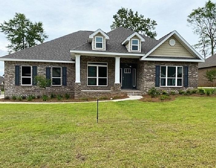 6074 Carina Road Crestview, FL 32539 - Photo 1 of 28 a front view of a house with garden