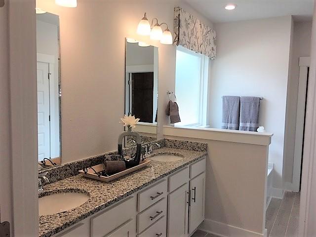 6074 Carina Road Crestview, FL 32539 - Photo 20 of 28 a bathroom with a granite countertop sink and a mirror