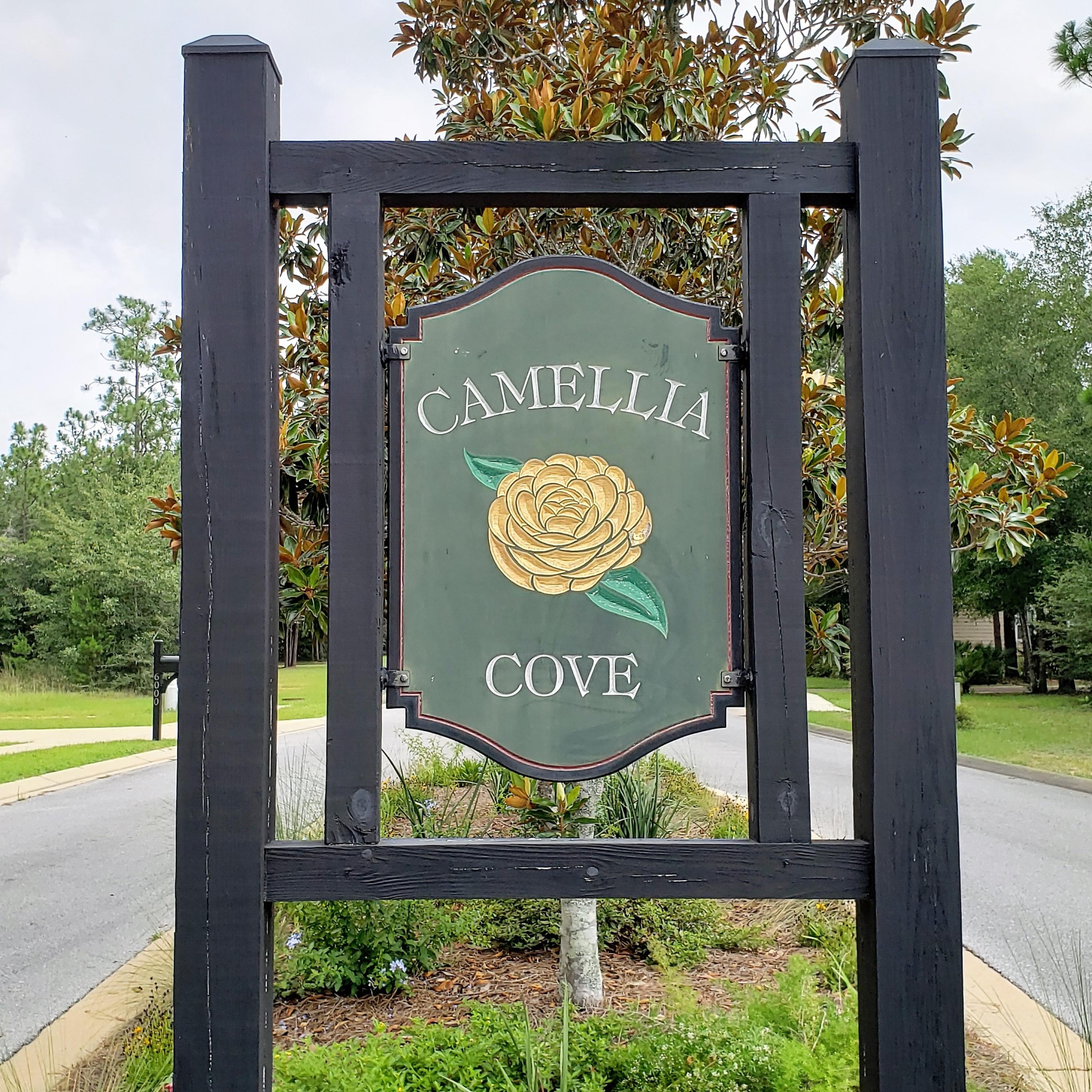 6074 Carina Road Crestview, FL 32539 - Photo 2 of 28 a sign on the wooden wall next to a road