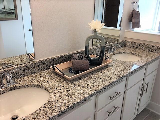 6074 Carina Road Crestview, FL 32539 - Photo 21 of 28 a bathroom with a granite countertop sink a mirror and vanity