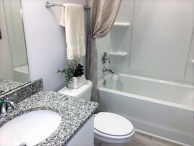 6074 Carina Road Crestview, FL 32539 - Photo 27 of 28 a bathroom with a granite countertop sink mirror vanity and toilet
