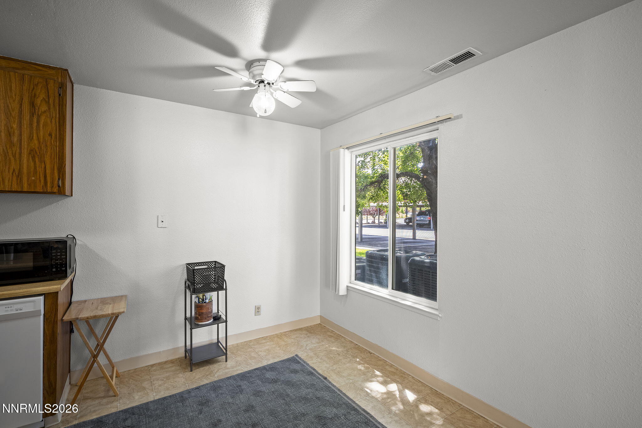 400 South Saliman Road, Unit 129 Carson City, NV 89701 - Photo 5 of 15 a view of an empty room with window and chandelier fan