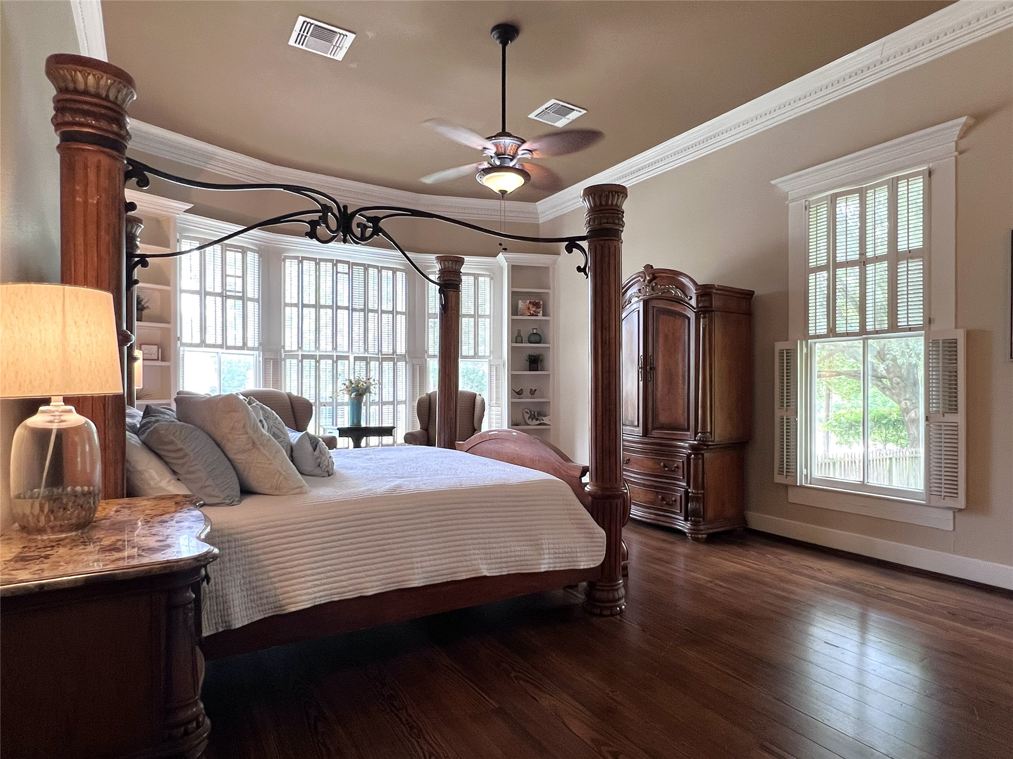 606 Sycamore Street Brenham, TX 77833 - Photo 9 of 27 a bedroom with a bed a dresser and windows