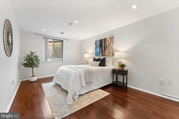a bed room with a bed and a potted plant