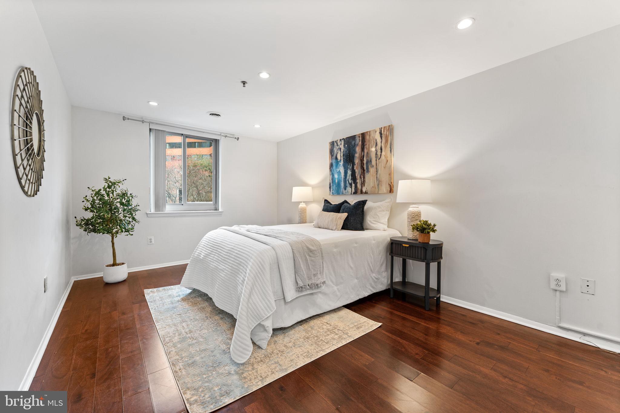 1001 North Vermont Street, Unit 103 Arlington, VA 22201 - Photo 12 of 20 a bed room with a bed and a potted plant