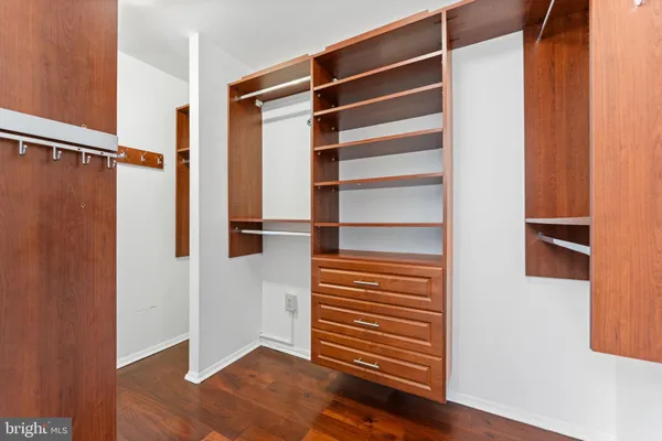 a view of walk in closet with empty racks