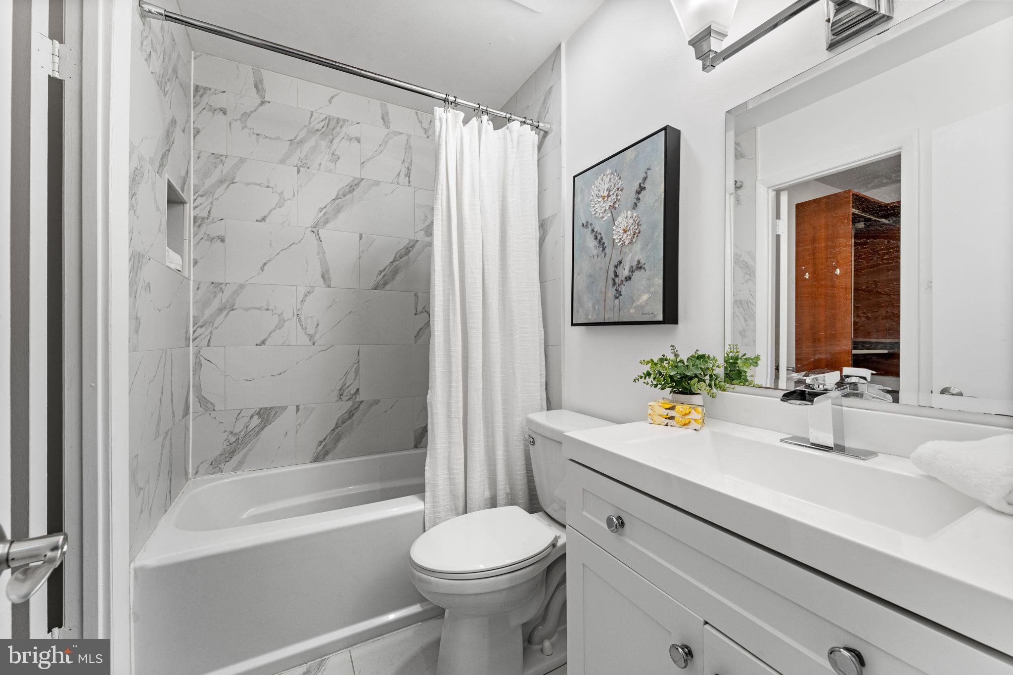 1001 North Vermont Street, Unit 103 Arlington, VA 22201 - Photo 15 of 20 a bathroom with a sink toilet and shower
