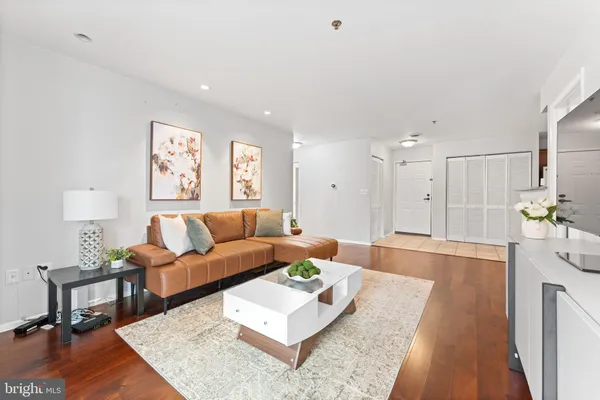a living room with furniture and a wooden floor