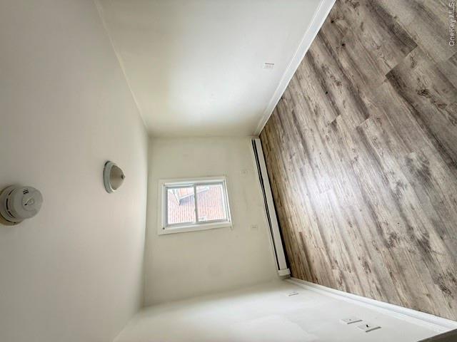 72 Chauncey Avenue New Rochelle, NY 10801 - Photo 4 of 14 an empty room with wooden floor and windows