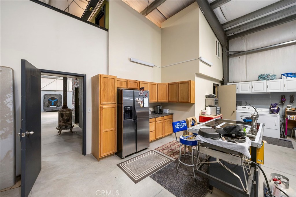2883 Soledad Canyon Road Acton, CA 93510 - Photo 29 of 64 a kitchen with a refrigerator and a stove top oven