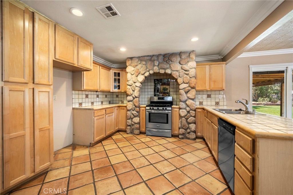 2883 Soledad Canyon Road Acton, CA 93510 - Photo 43 of 64 a kitchen with a sink a counter top space stainless steel appliances and cabinets