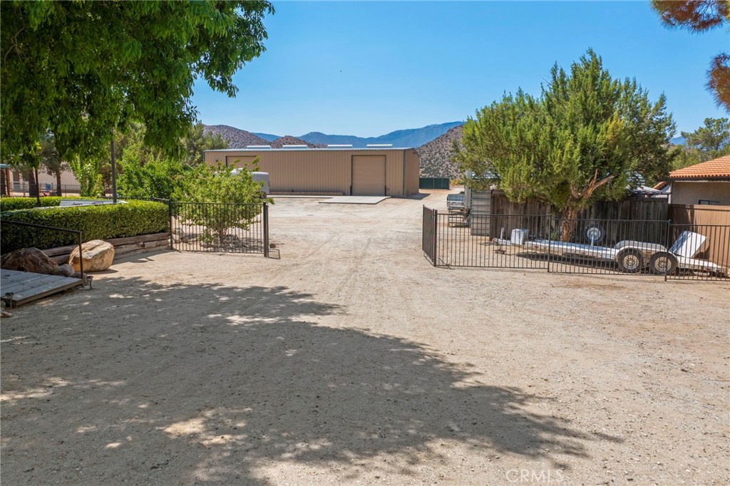 2883 Soledad Canyon Road Acton, CA 93510 - Photo 10 of 64 a view of a patio with a table and chairs under an umbrella