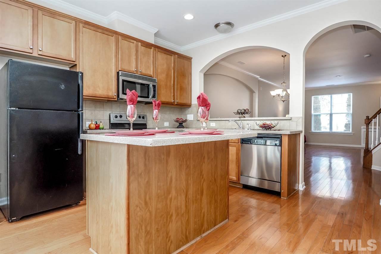 2965 Casona Way Raleigh, NC 27616 - Photo 14 of 25 a kitchen with stainless steel appliances granite countertop a stove a sink and a refrigerator