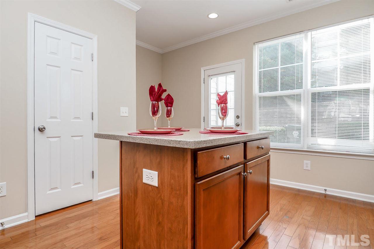 2965 Casona Way Raleigh, NC 27616 - Photo 16 of 25 a view of a kitchen with an empty table and a window