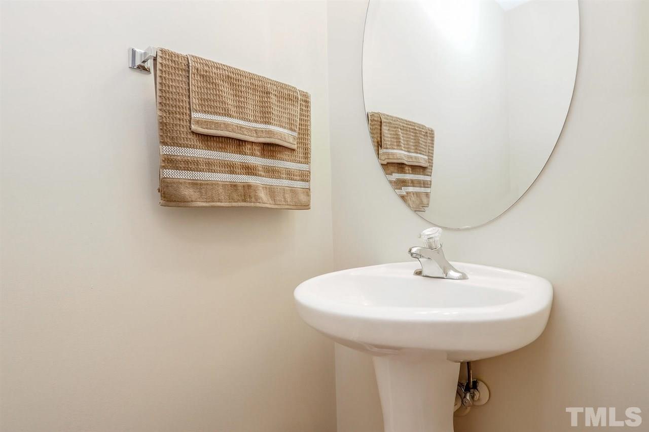 2965 Casona Way Raleigh, NC 27616 - Photo 17 of 25 a bathroom with a sink and a mirror