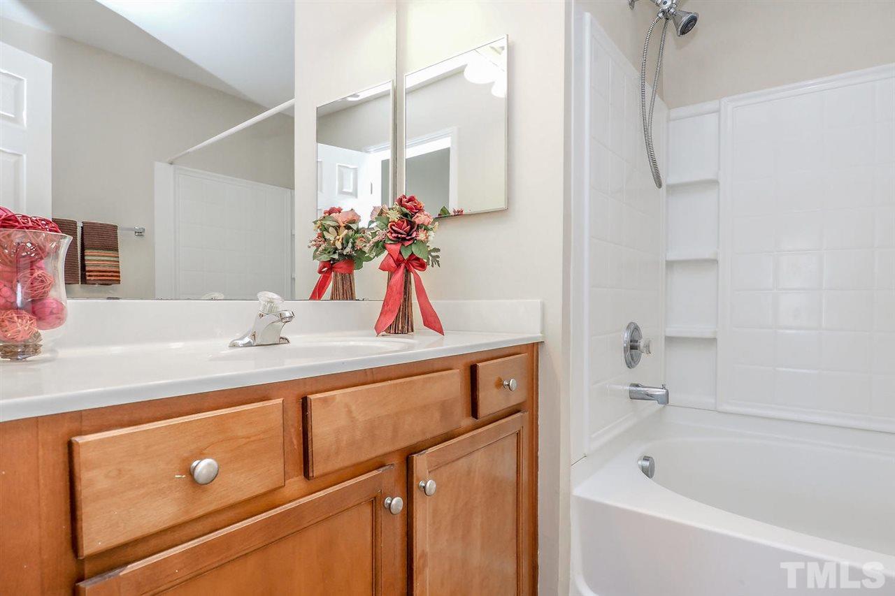 2965 Casona Way Raleigh, NC 27616 - Photo 23 of 25 a bathroom with a tub sink and mirror