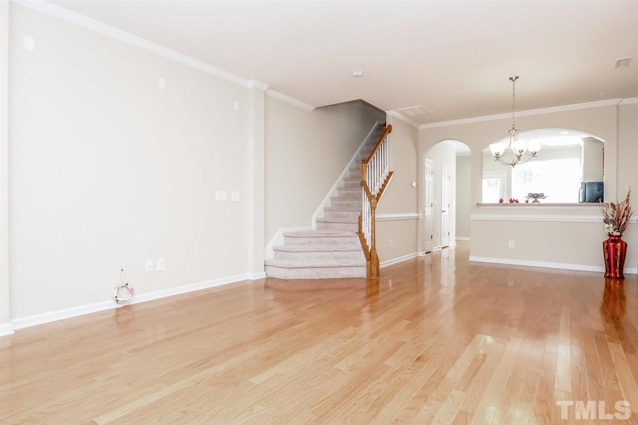 2965 Casona Way Raleigh, NC 27616 - Photo 7 of 25 a view of a room with wooden floor and staircase