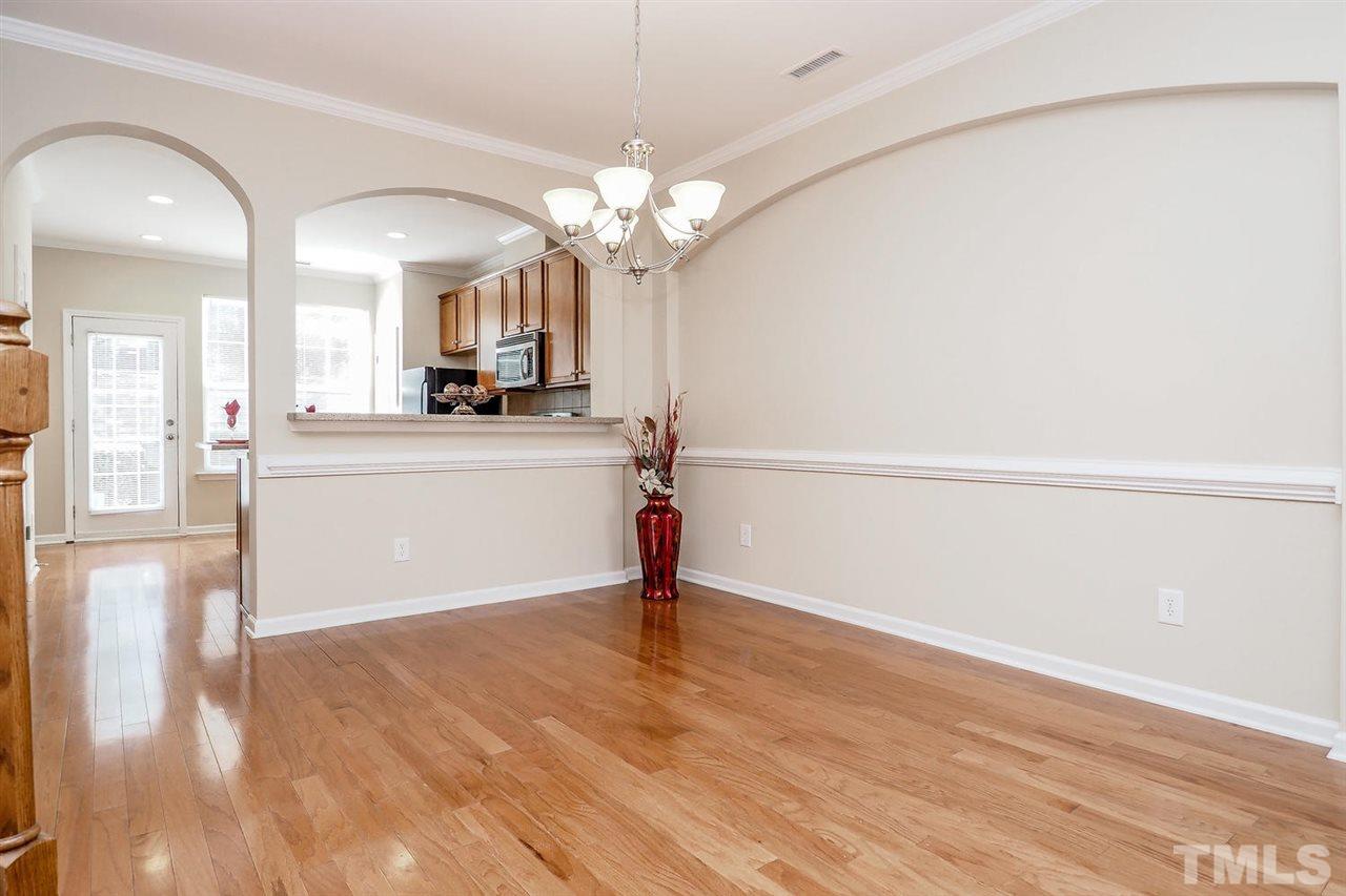 2965 Casona Way Raleigh, NC 27616 - Photo 10 of 25 a view of a kitchen with wooden floor and a chandelier