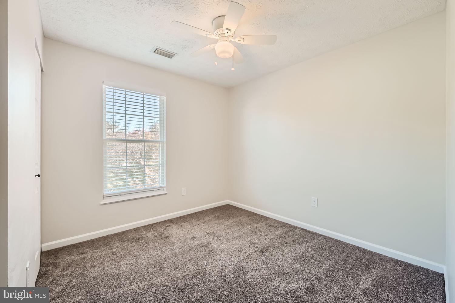 8540 Pine Meadows Drive Odenton, MD 21113 - Photo 20 of 29 an empty room with a window and a fan