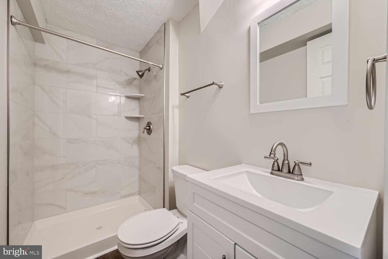 8540 Pine Meadows Drive Odenton, MD 21113 - Photo 25 of 29 a bathroom with a sink toilet and shower