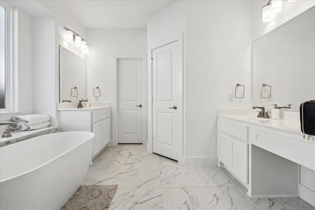 1710 Highwood Road Forney, TX 75126 - Photo 20 of 25 Freestanding oval soaking tub complemented by marble-finish tile flooring
