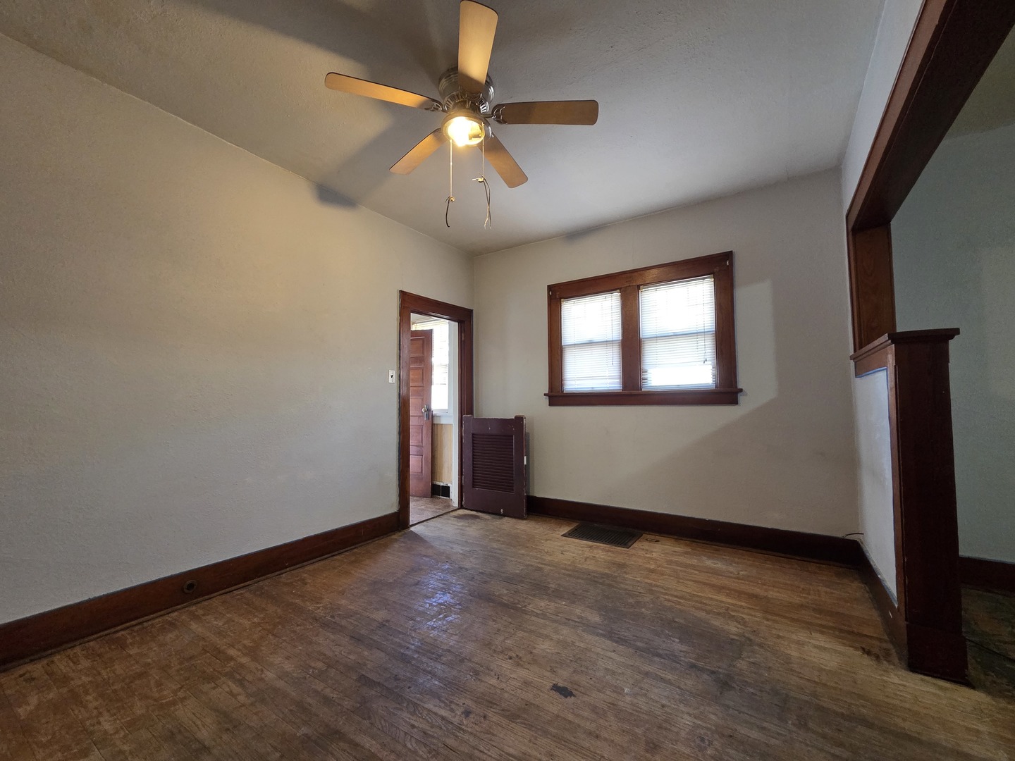 2410 Camanche Avenue Clinton, IA 52732 - Photo 9 of 15 an empty room with wooden floor fan and windows