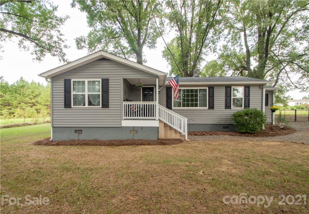 2612 Long Hope Road Monroe, NC 28112 - Photo 3 of 32 a front view of a house with a garden