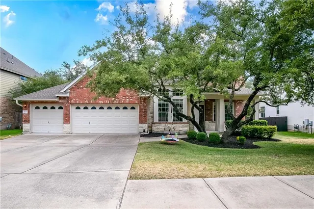 a white house that has a tree in front of it