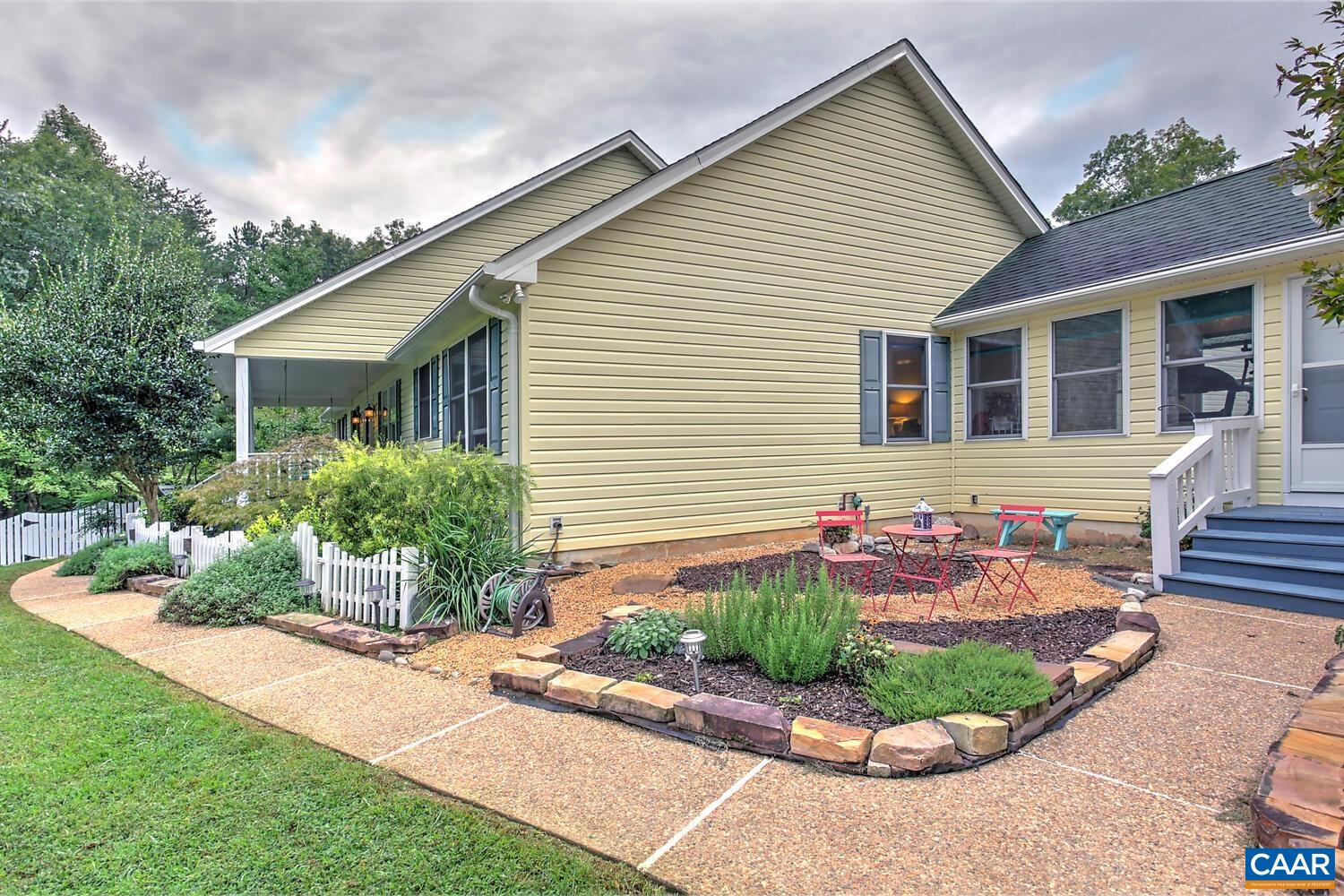 340 Beaver Pond Ridge Troy, VA 22974 - Photo 15 of 53 a front view of a house with a garden and plants
