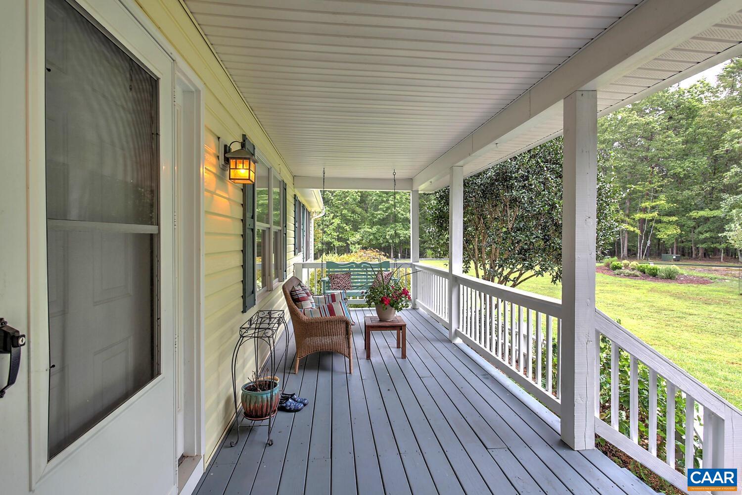 340 Beaver Pond Ridge Troy, VA 22974 - Photo 18 of 53 a view of a balcony with chairs and wooden floor