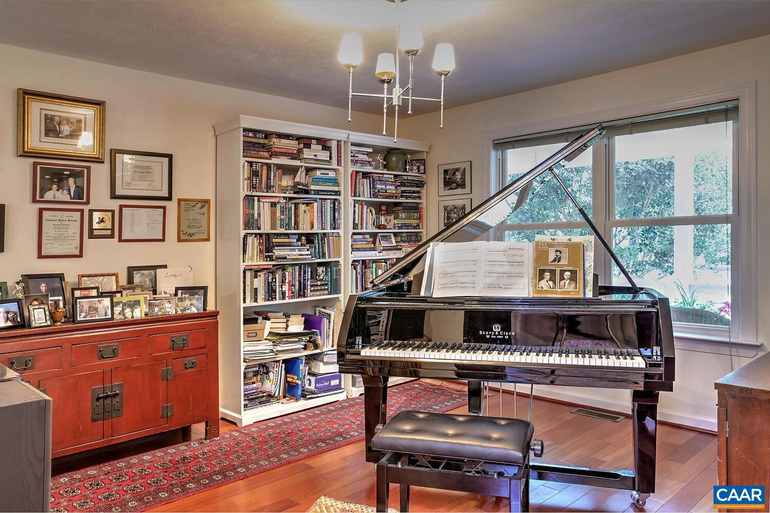 340 Beaver Pond Ridge Troy, VA 22974 - Photo 20 of 53 a living room with furniture a piano and a bookshelf