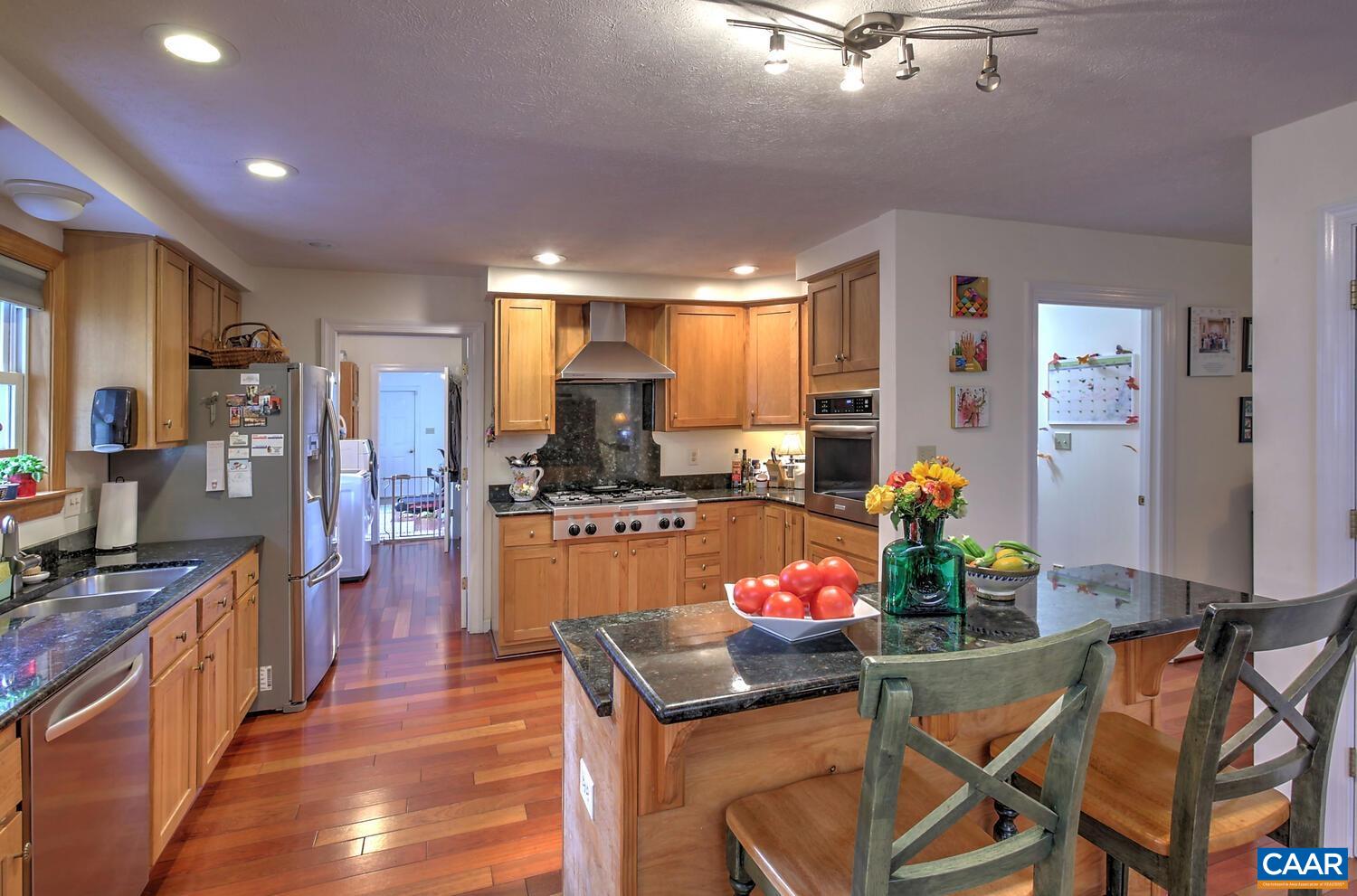 340 Beaver Pond Ridge Troy, VA 22974 - Photo 4 of 53 a kitchen with stainless steel appliances kitchen island granite countertop a refrigerator a stove top oven and a sink