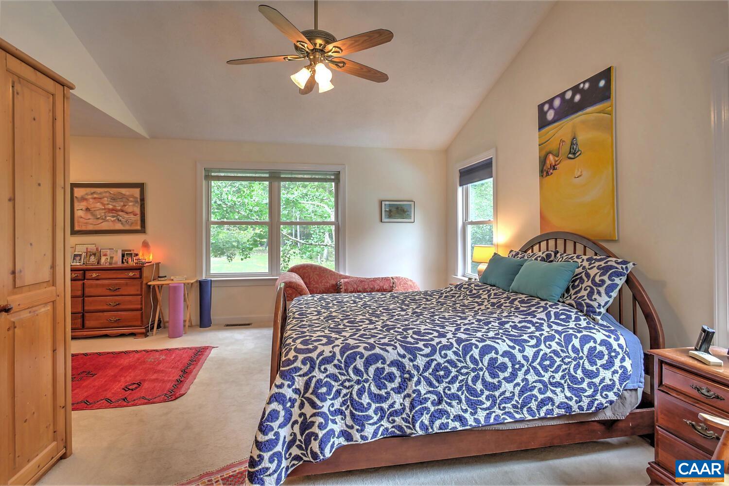 340 Beaver Pond Ridge Troy, VA 22974 - Photo 7 of 53 a bedroom with a large bed and a chandelier