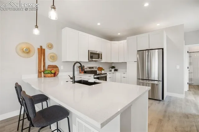 a kitchen with refrigerator cabinets and chairs