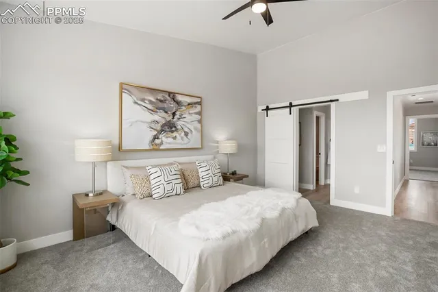 a bedroom with a bed and a painting on the wall