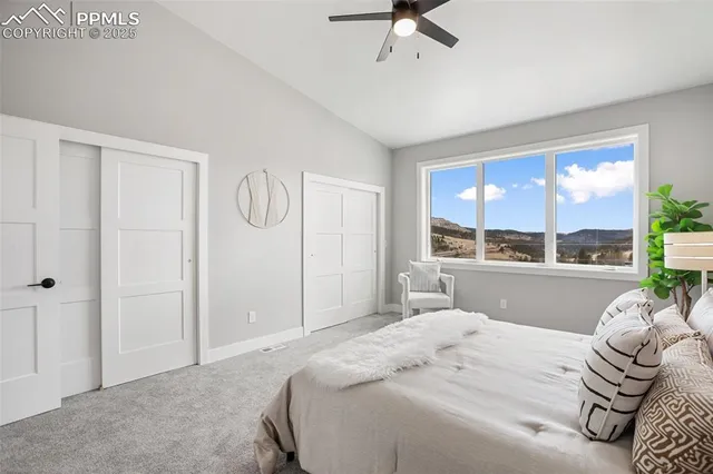 a bedroom with a large bed and a large window