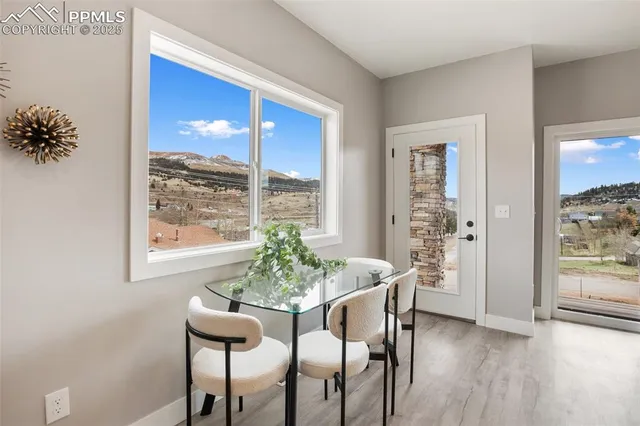 a dining room with furniture window and wooden floor