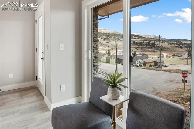 a view of a room with a large window and chair