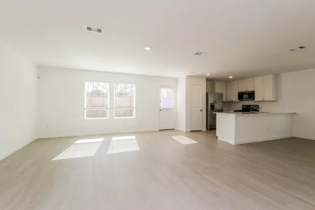 a view of a room with a sink and cabinets
