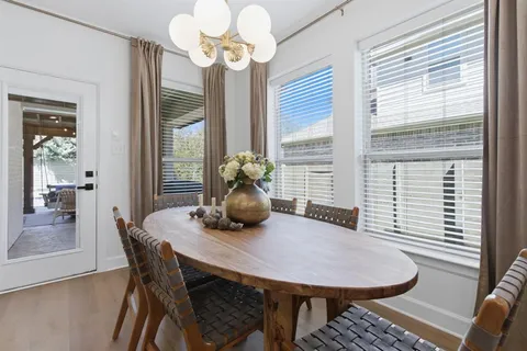 a view of a dining room with furniture wooden floor and chandelier