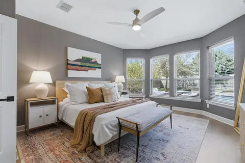a spacious bedroom with a bed and a large window