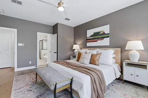 a spacious bedroom with a bed and a lamp