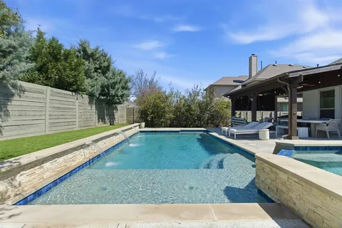 a view of a house with swimming pool and sitting area