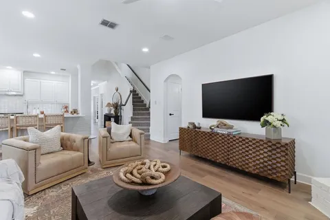 a kitchen with kitchen island granite countertop lots of white stainless steel appliances cabinets and a sink
