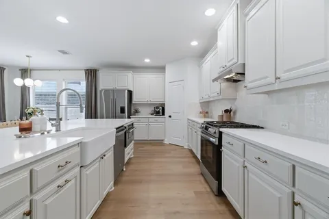 a kitchen with a table and chairs in it