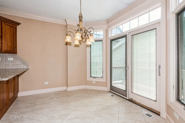 a view of a hallway with chandelier and entryway
