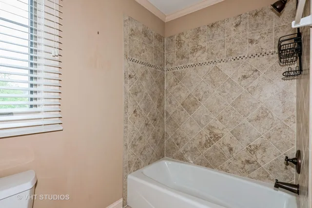 a bathroom with a bathtub and shower