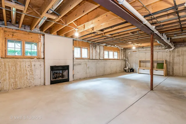 a view of an empty room with a fireplace and a window