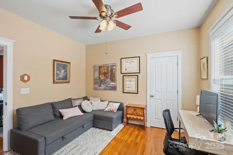 a view of a patio with table and chairs and wooden fence
