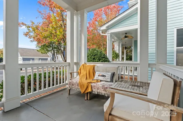 a view of a chair and tables in the balcony